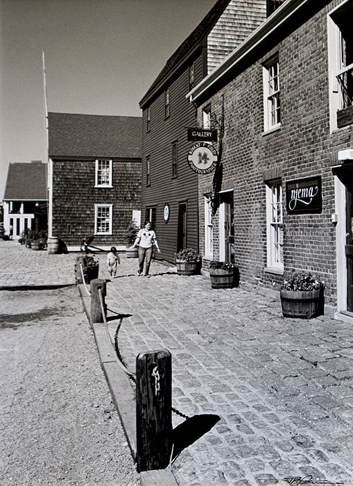 A mid 19th century photo of Historic Bowen's Wharf. The building on the right is the Anne Hall Antique Prints Gallery located at 10 Bowen's Wharf. With a deep water wharf, history ties to the early 1700's. in part of Newport Rhode Island's, most historic section of the City. The upstairs of the brick building, today houses an extraordinary collection of maps & prints over 100 years old.