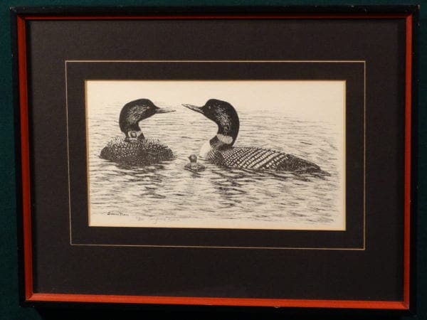 framed piece of loon artwork signed by artist.